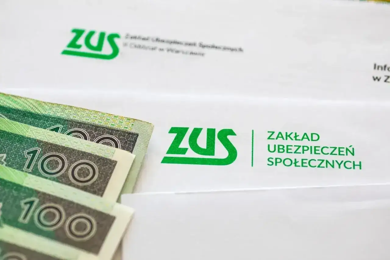 Symbol ZUS i numer świadczenia znajdziesz na dokumentach. Pieniądze na pierwszym planie sugerują wypłatę.
